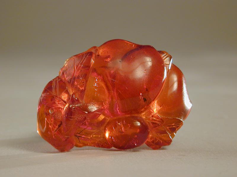 Amber Carving of a Peach and Insect on a Leaf