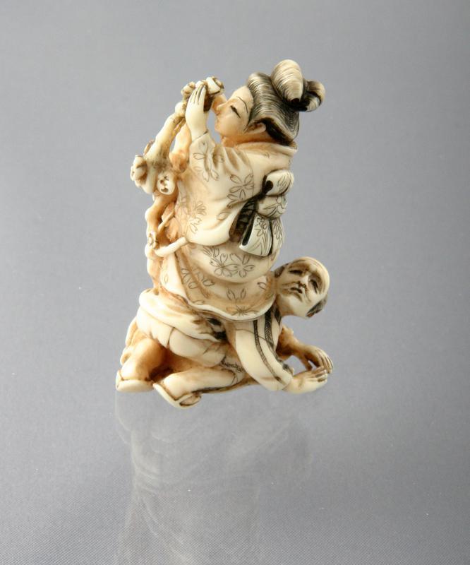 Netsuke: Woman with Servant Examining Plum Blossoms