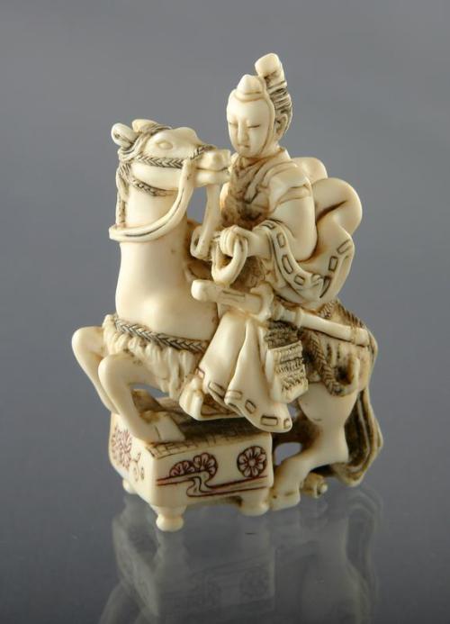 Netsuke: Oguri Hangan Persuading his Horse to Kneel on a Go Board