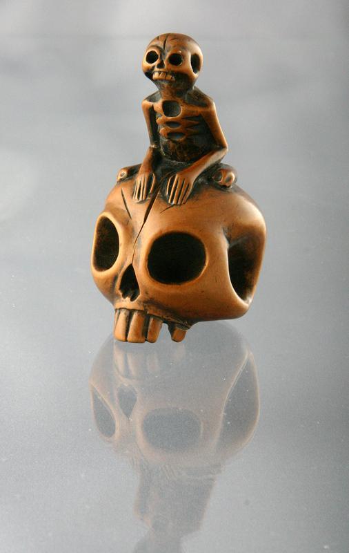 Netsuke of A Skeleton on a Skull