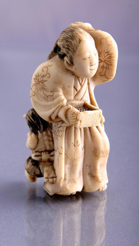 Netsuke: Ivory Figure of a Woman in a Kimono Casting Beans