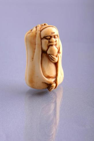 Netsuke: Ivory Figure of a Daruma with a Peach