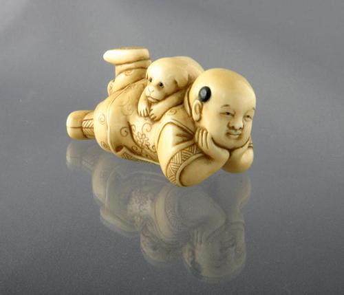 Ivory Netsuke of a Chinese Boy with a Puppy