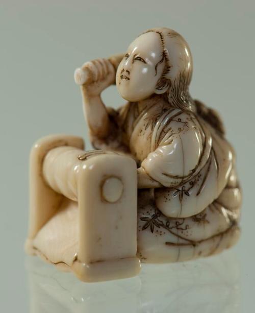 Netsuke of Woman Beating Cloth