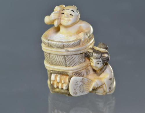 Netsuke (Man washing in tub)