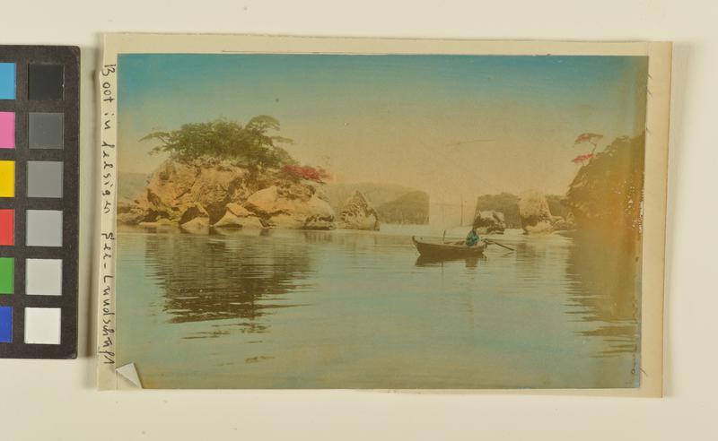 Untitled (boat by small rock island)