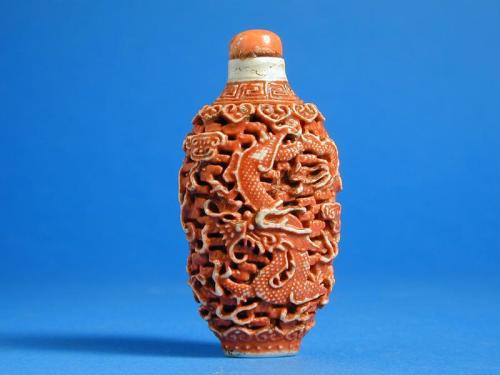 Snuff Bottle with reticulated & relief sides having a depiction of a dragon & phoenix in the clouds