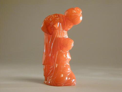 An Amber Figurine of a Turkish Slave Dealer with Kneeling Girl